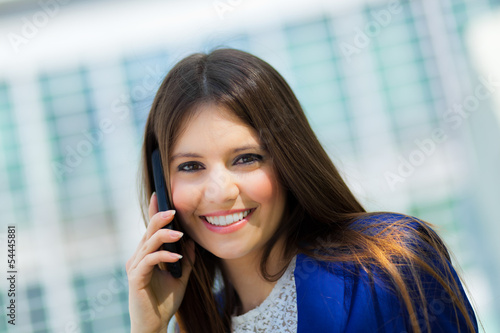 Photo: Smiling businesswoman talking at the phone Smiling businesswoman talking at the phone