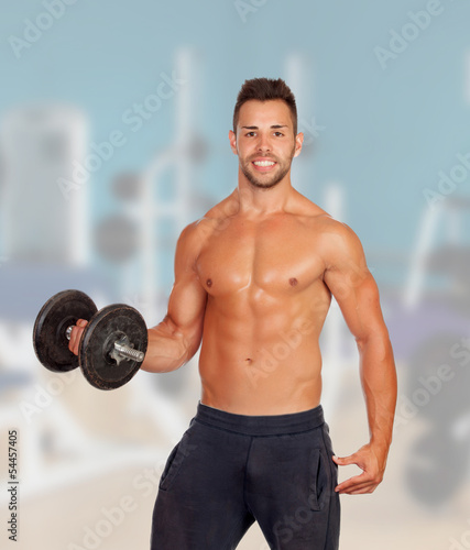 Photo: Muscled guy lifting weights Muscled guy lifting weights