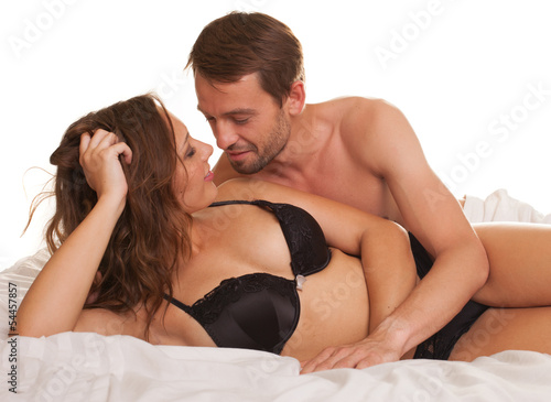 Photo: Young man and woman in bed. Couple. Young man and woman in bed. Couple.