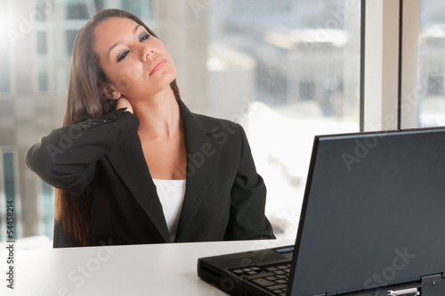 Photo: Businesswoman Sitting at Her Desk Tired Businesswoman Sitting at Her Desk Tired