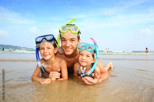 Photo: Portrait of father and children wearing diving mask Portrait of father and children wearing diving mask