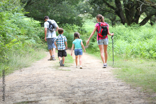 Photo: Back view of family on a trekking day in countryside Back view of family on a trekking day in countryside