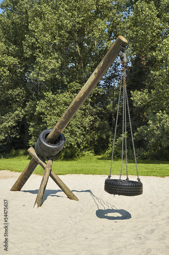 Photo: Tire swing hanging in park Tire swing hanging in park