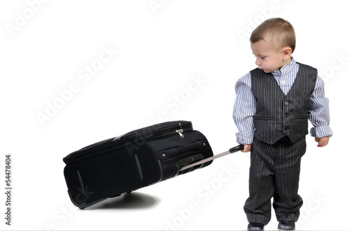 Photo: small boy carrying a suitcase small boy carrying a suitcase