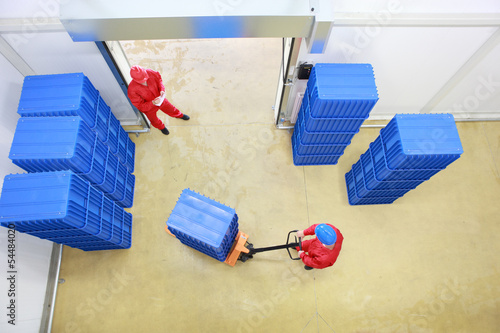 Photo: workers preparing goods delivery in a small company warehouse workers preparing goods delivery in a small company warehouse