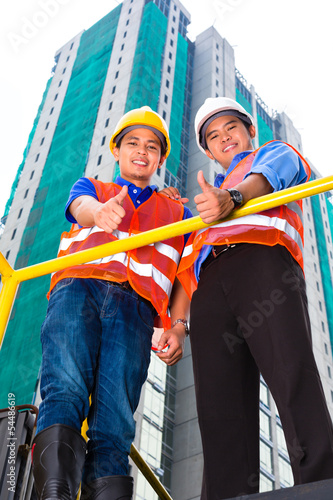 Photo: Asian architect and supervisor on construction site Asian architect and supervisor on construction site
