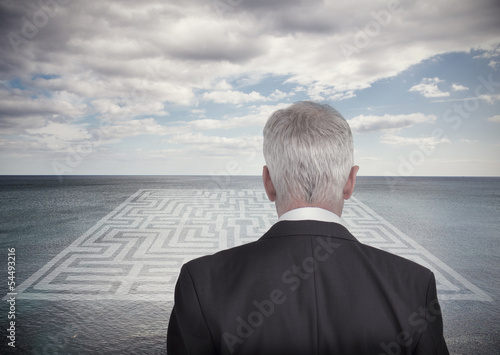 Photo: Businessman looking at landscape and maze Businessman looking at landscape and maze
