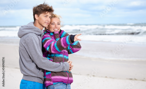 Photo: Couple embracing and having fun wearing warm clothes outside on Couple embracing and having fun wearing warm clothes outside on
