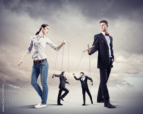 Photo: Businesspeople with marionettes Businesspeople with marionettes