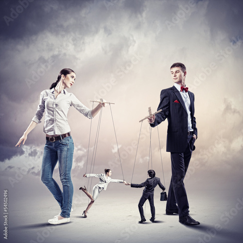 Photo: Businesspeople with marionettes Businesspeople with marionettes