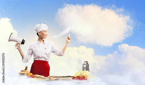 Photo: Asian female cook holding megaphone Asian female cook holding megaphone