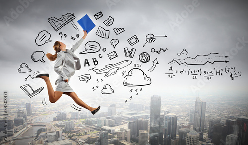 Photo: Businesswoman holding folder and jumping Businesswoman holding folder and jumping