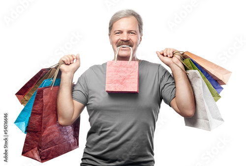Photo: smiling mature man holding shopping bags isolated on white backg smiling mature man holding shopping bags isolated on white backg