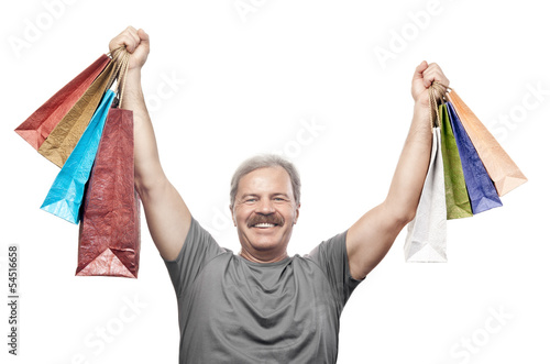 Photo: smiling mature man holding shopping bags isolated on white backg smiling mature man holding shopping bags isolated on white backg