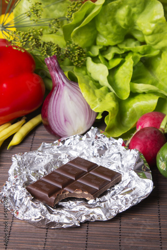 Photo: vegetables and chocolate on wood vegetables and chocolate on wood