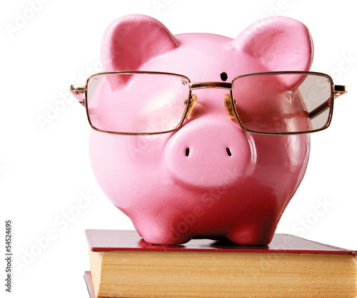 Photo: piggy bank with glasses and book isolated white background piggy bank with glasses and book isolated white background