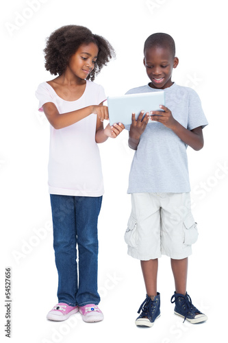 Photo: Brother and sister using tablet pc Brother and sister using tablet pc