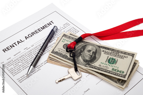 Photo: House key and cash with rental agreement House key and cash with rental agreement