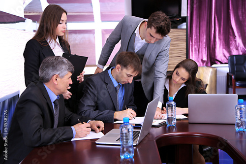 Photo: Business people working in conference room Business people working in conference room