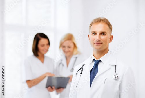 Photo: male doctor with colleagues male doctor with colleagues