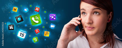 Photo: Young woman calling by phone with various icons Young woman calling by phone with various icons