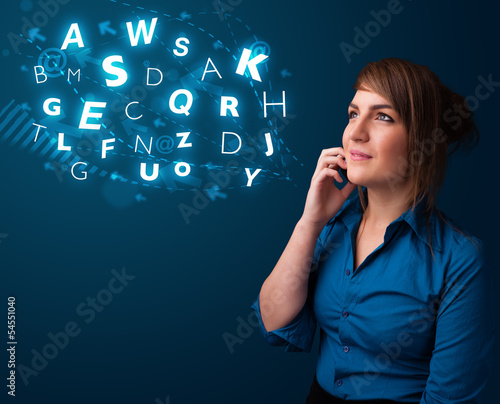 Photo: Young lady making phone call with shiny characters Young lady making phone call with shiny characters