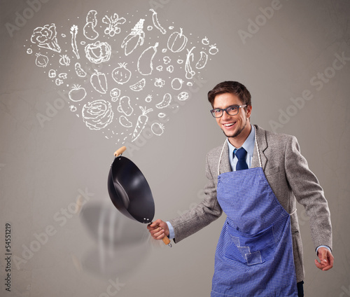 Photo: Attractive man cooking vegetables Attractive man cooking vegetables