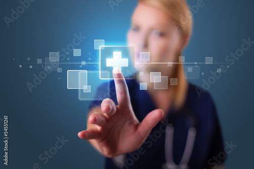 Photo: Young nurse pressing modern medical type of buttons Young nurse pressing modern medical type of buttons