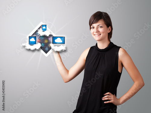 Photo: young woman holding tablet with modern devices in clouds young woman holding tablet with modern devices in clouds