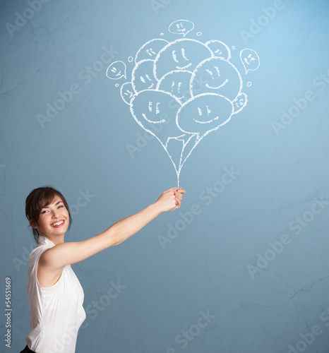 Photo: Happy woman holding smiling balloons drawing Happy woman holding smiling balloons drawing