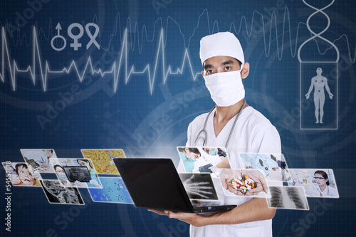 Photo: Doctor looking at digital picture on laptop Doctor looking at digital picture on laptop