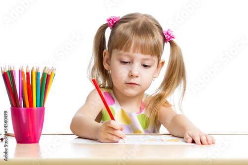 Photo: cute child drawing with colorful pencils cute child drawing with colorful pencils