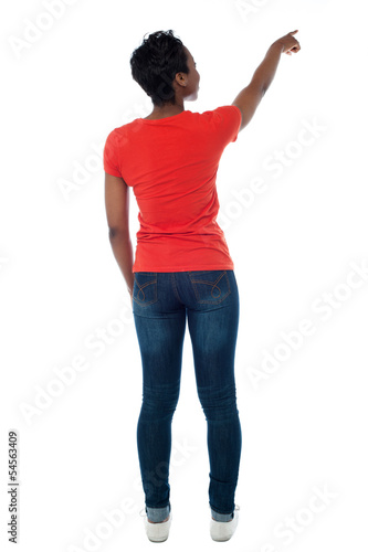Photo: Casual african woman pointing at something Casual african woman pointing at something