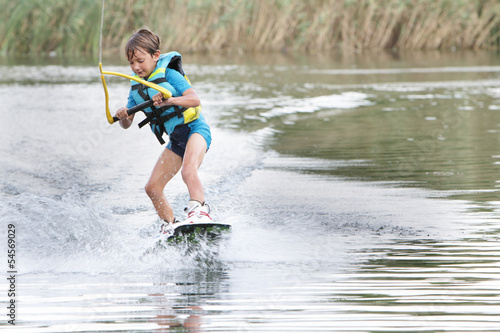 Photo: young boy wakeboarding young boy wakeboarding