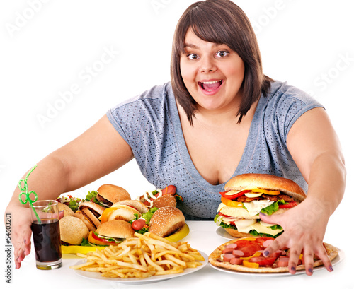 Photo: Woman eating fast food. Woman eating fast food.