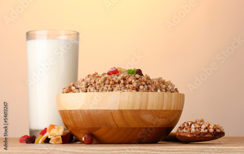Photo: Boiled buckwheat in a wooden bowl with a glass of milk Boiled buckwheat in a wooden bowl with a glass of milk