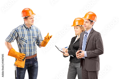 Photo: Manual worker having a conversation with architects Manual worker having a conversation with architects