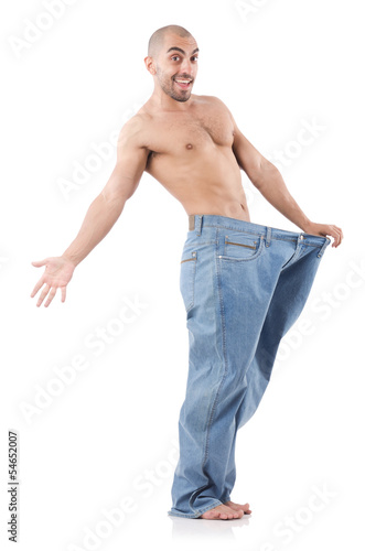 Photo: Man in dieting concept with oversized jeans Man in dieting concept with oversized jeans