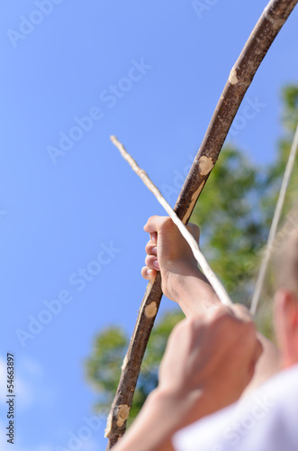 Photo: Child taking aim with an arrow Child taking aim with an arrow