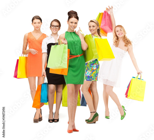 Photo: attractive girls holding color shopping bags attractive girls holding color shopping bags