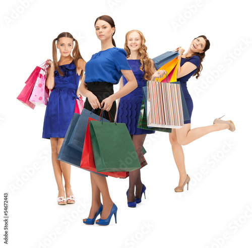 Photo: attractive girls holding color shopping bags attractive girls holding color shopping bags
