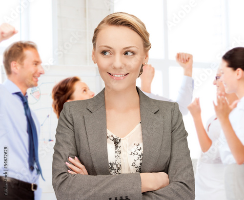 Photo: businesswoman celebrating succes in office businesswoman celebrating succes in office