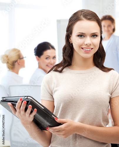 Photo: businesswoman with tablet pc in office businesswoman with tablet pc in office