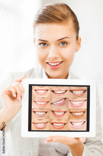 Photo: female doctor with tablet pc and smiles female doctor with tablet pc and smiles