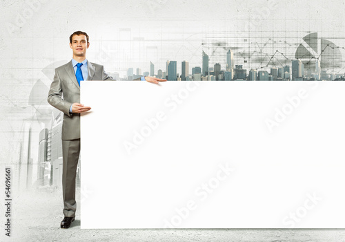 Photo: Businessman with blank banner Businessman with blank banner