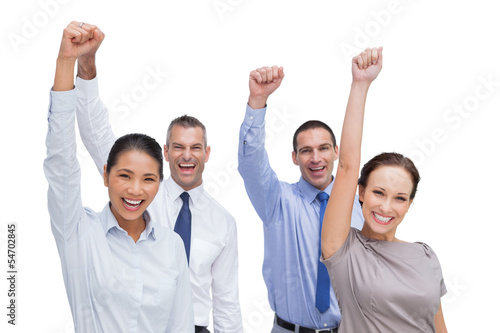 Photo: Cheerful work team posing with hands up Cheerful work team posing with hands up