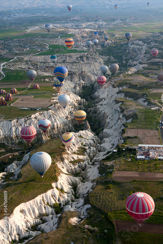 Photo: Hot air balloons rise over valley in Cappadocia, Turkey Hot air balloons rise over valley in Cappadocia, Turkey
