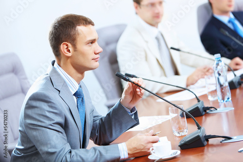 Photo: Three businesspeople at meeting Three businesspeople at meeting