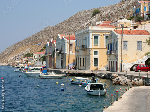 Photo: Typical Symi Houses and Boats by the Sea Typical Symi Houses and Boats by the Sea