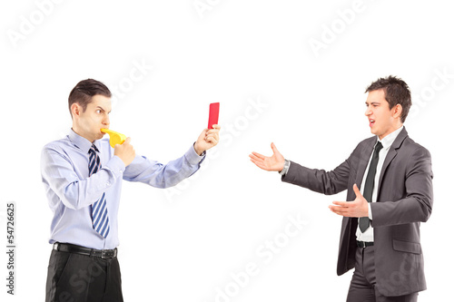 Photo: Guy showing a red card and blowing a whistle to a businessman Guy showing a red card and blowing a whistle to a businessman
